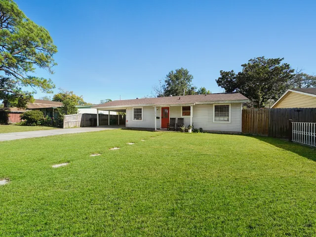 a front view of a house with a garden