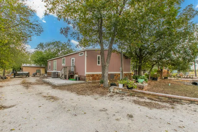 a view of a dirt road and a building