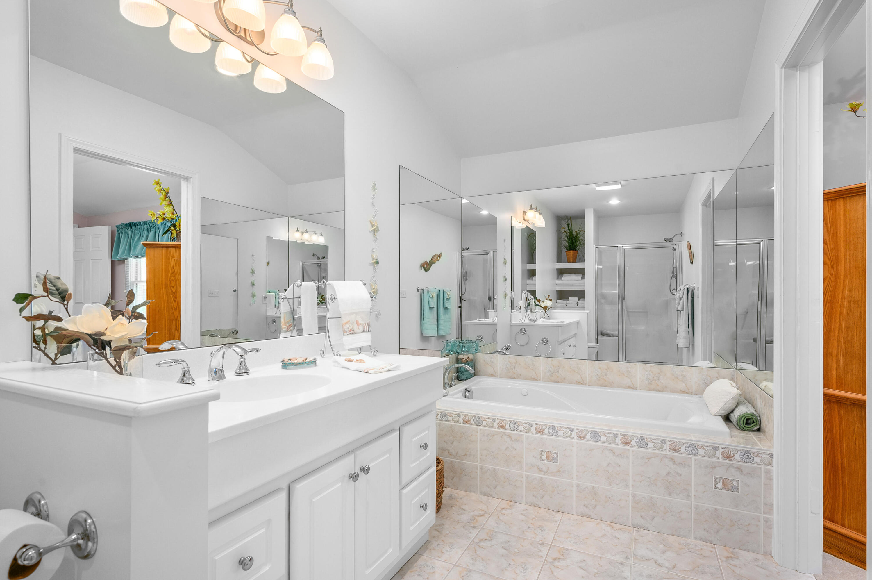 45 First Way Barnstable, MA 02630 - Photo 20 of 30 a bathroom with a bathtub a double vanity sink and a mirror