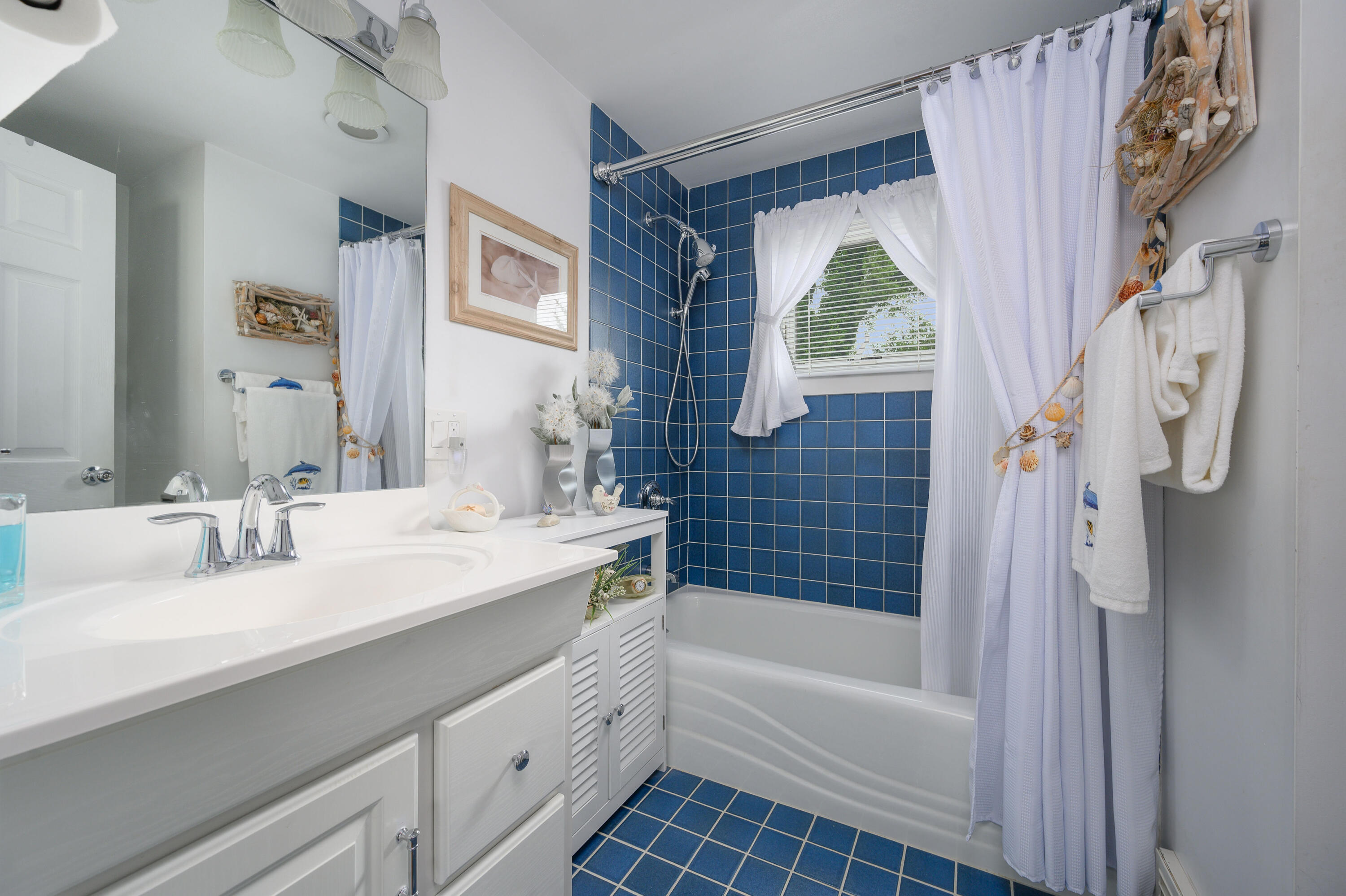 45 First Way Barnstable, MA 02630 - Photo 25 of 30 a bathroom with a bathtub sink and mirror