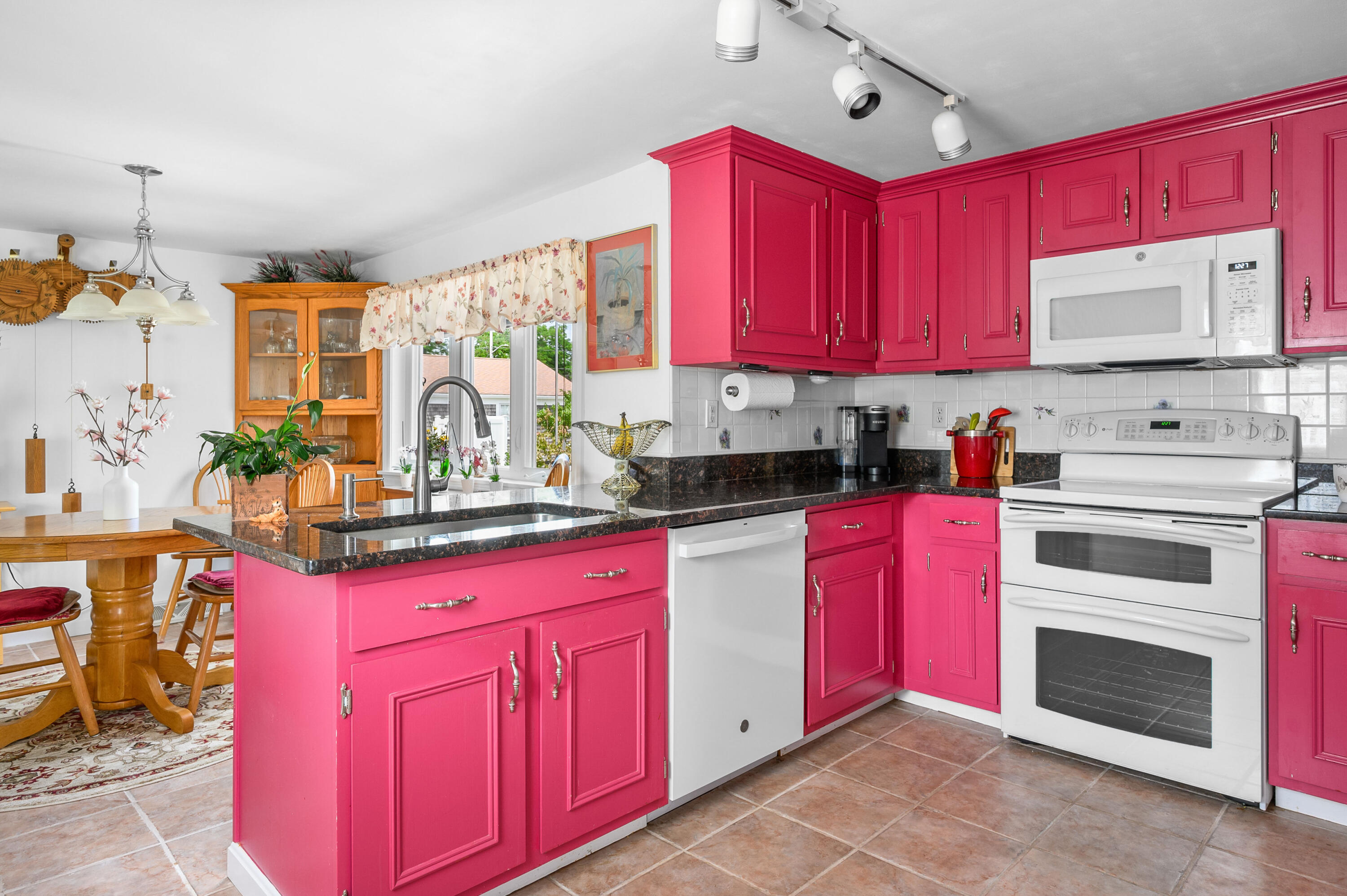 45 First Way Barnstable, MA 02630 - Photo 8 of 30 a kitchen with granite countertop a stove top oven sink and cabinets