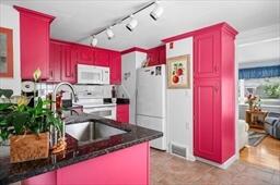 45 First Way Barnstable, MA 02630 - Photo 9 of 30 a kitchen with stainless steel appliances granite countertop a refrigerator sink and wooden cabinets