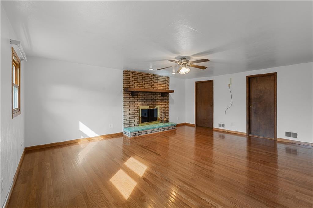 2807 Russelton Road Tarentum, PA 15084 - Photo 19 of 28 a view of an empty room with wooden floor fireplace and a window