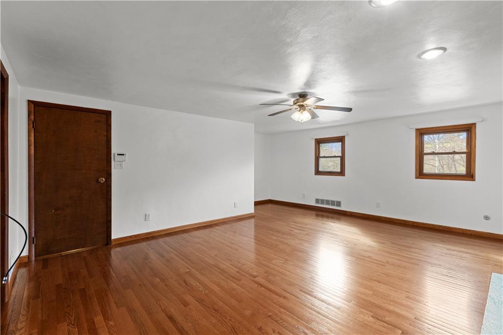 2807 Russelton Road Tarentum, PA 15084 - Photo 20 of 28 an empty room with wooden floor chandelier fan and windows