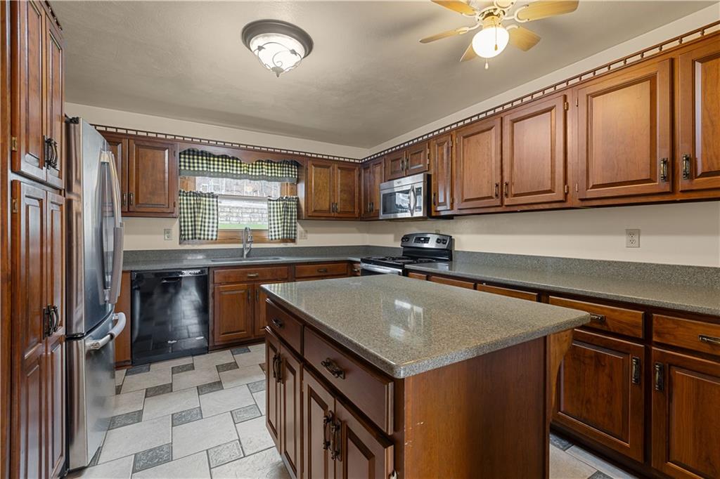 2807 Russelton Road Tarentum, PA 15084 - Photo 10 of 28 a kitchen with a sink a stove cabinets and a counter top space