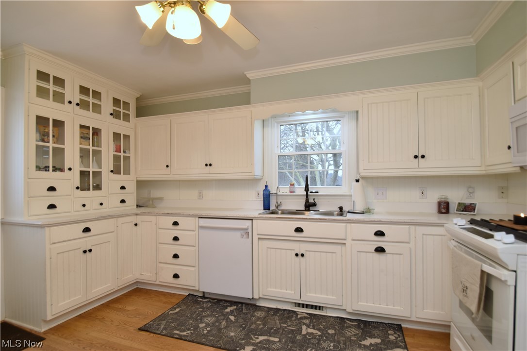 149 North Medina Line Road Akron, OH 44333 - Photo 7 of 36 Kitchen with white cabinetry and appliances and hardwood floors