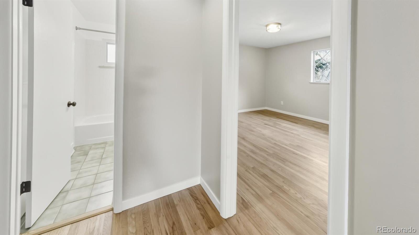 1201 Reed Street Lakewood, CO 80214 - Photo 15 of 44 a view of a hallway with wooden floor