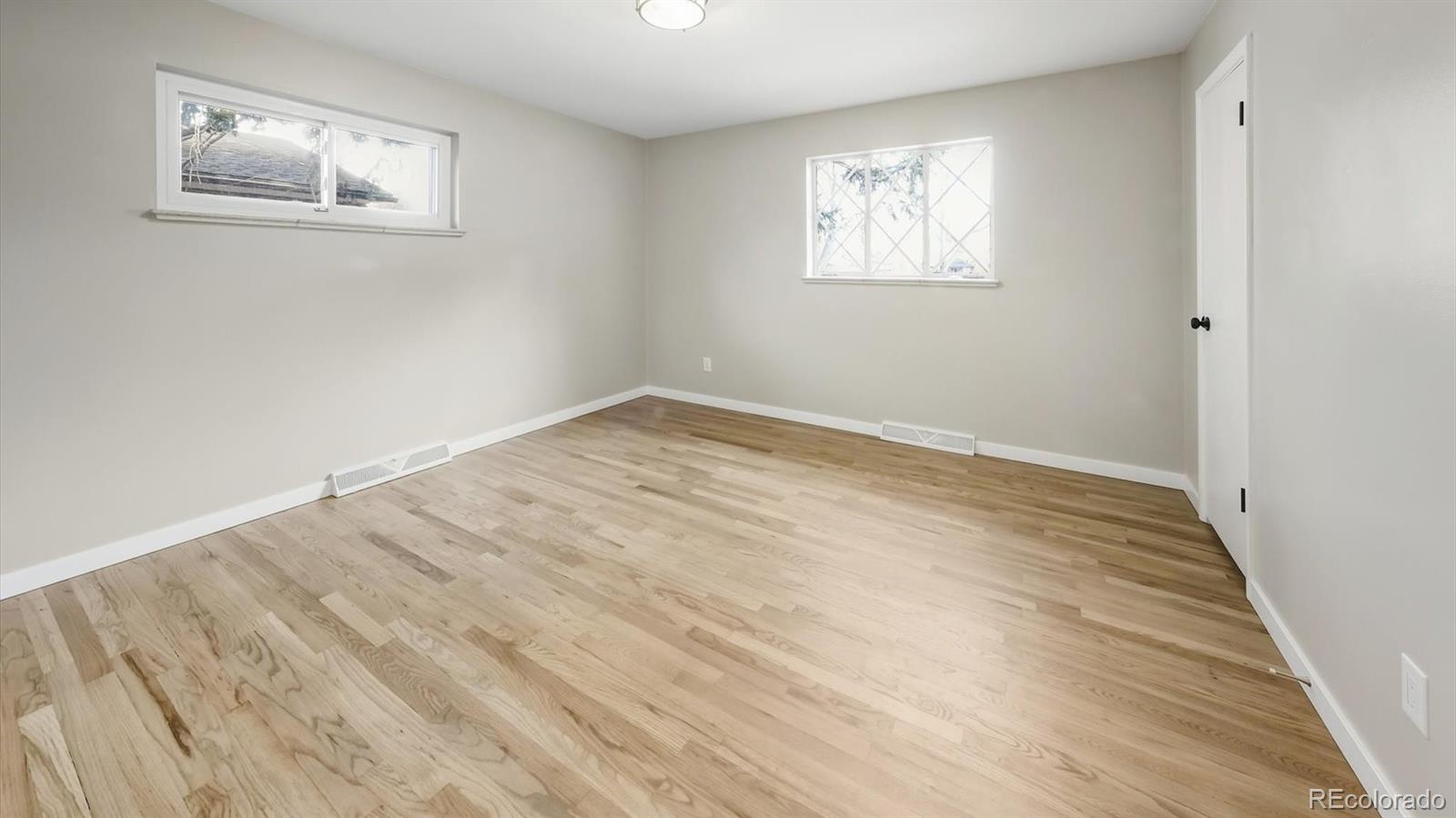1201 Reed Street Lakewood, CO 80214 - Photo 16 of 44 a view of empty room with wooden floor