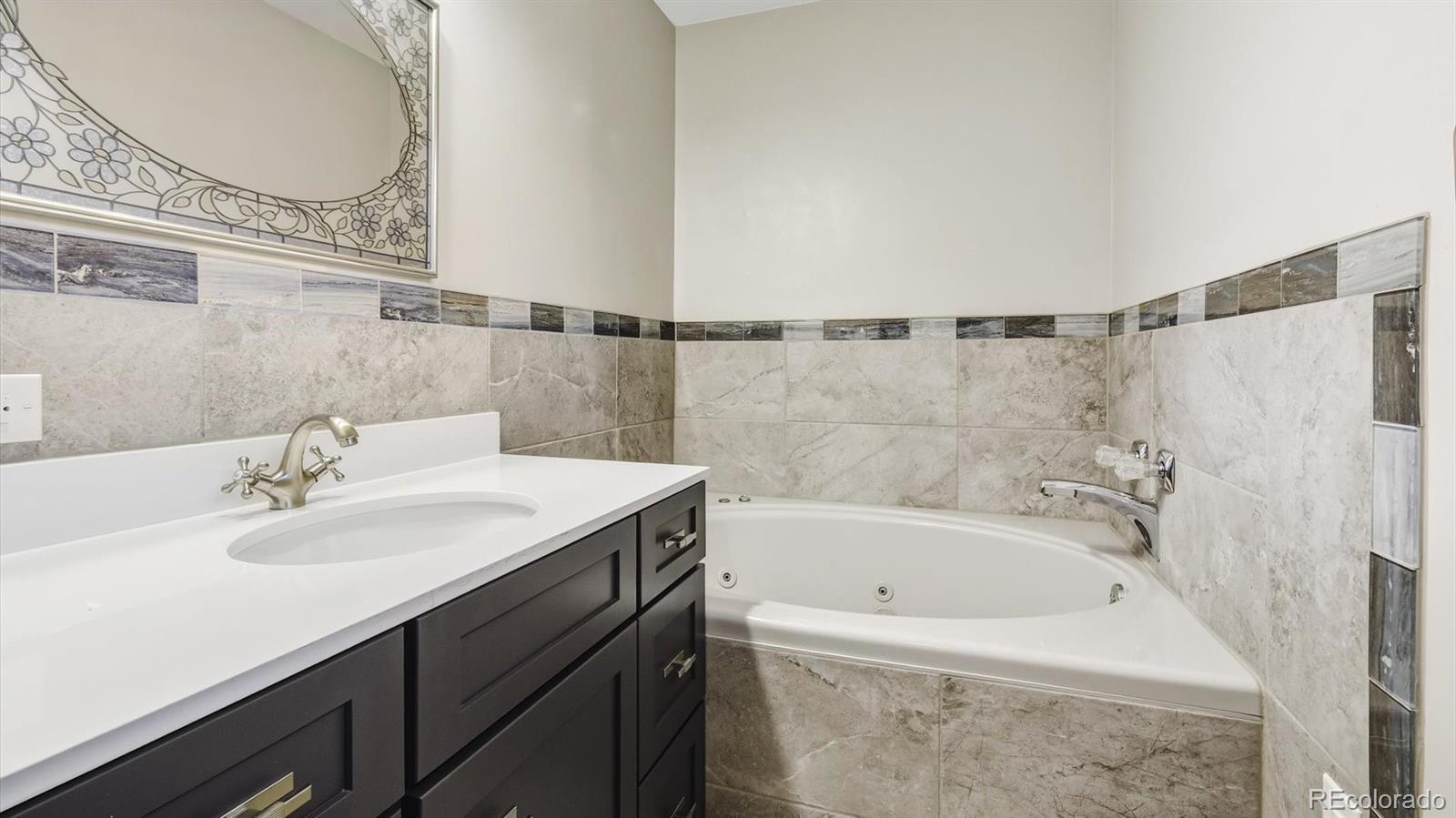 1201 Reed Street Lakewood, CO 80214 - Photo 21 of 44 a bathroom with a sink and a bathtub
