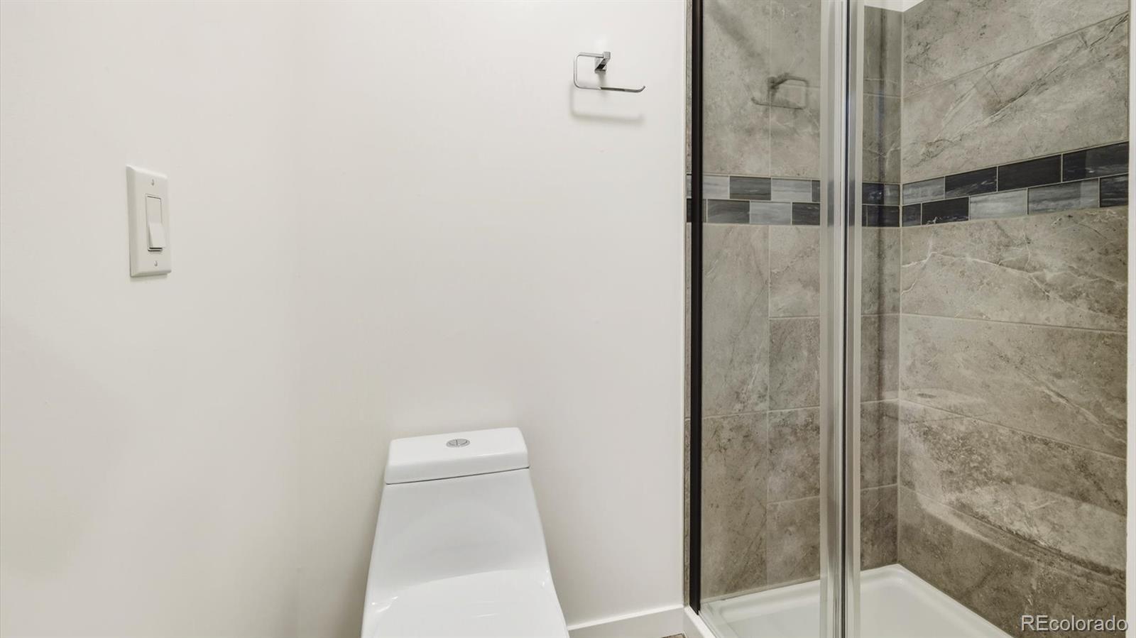 1201 Reed Street Lakewood, CO 80214 - Photo 22 of 44 a bathroom with a shower