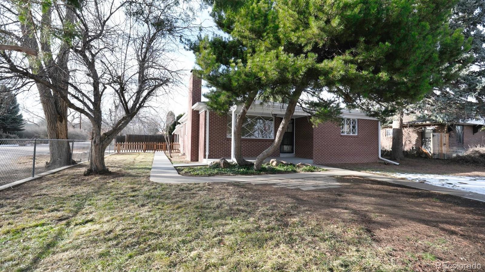 1201 Reed Street Lakewood, CO 80214 - Photo 3 of 44 a backyard of a house with barbeque oven and outdoor seating