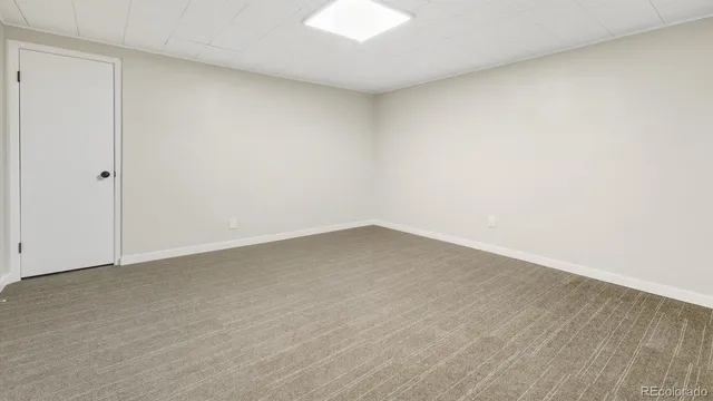 a view of an empty room and wooden floor
