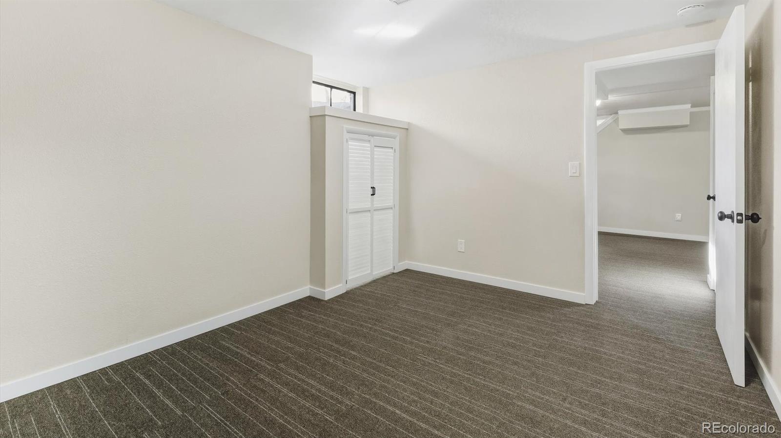 1201 Reed Street Lakewood, CO 80214 - Photo 36 of 44 a view of an empty room with wooden floor