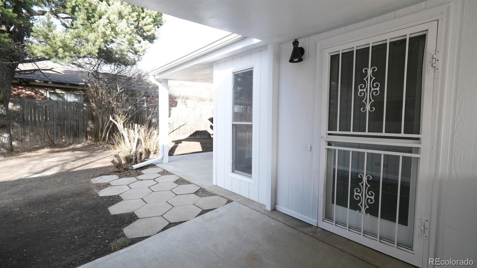 1201 Reed Street Lakewood, CO 80214 - Photo 38 of 44 a view of a porch with wooden floor and a yard