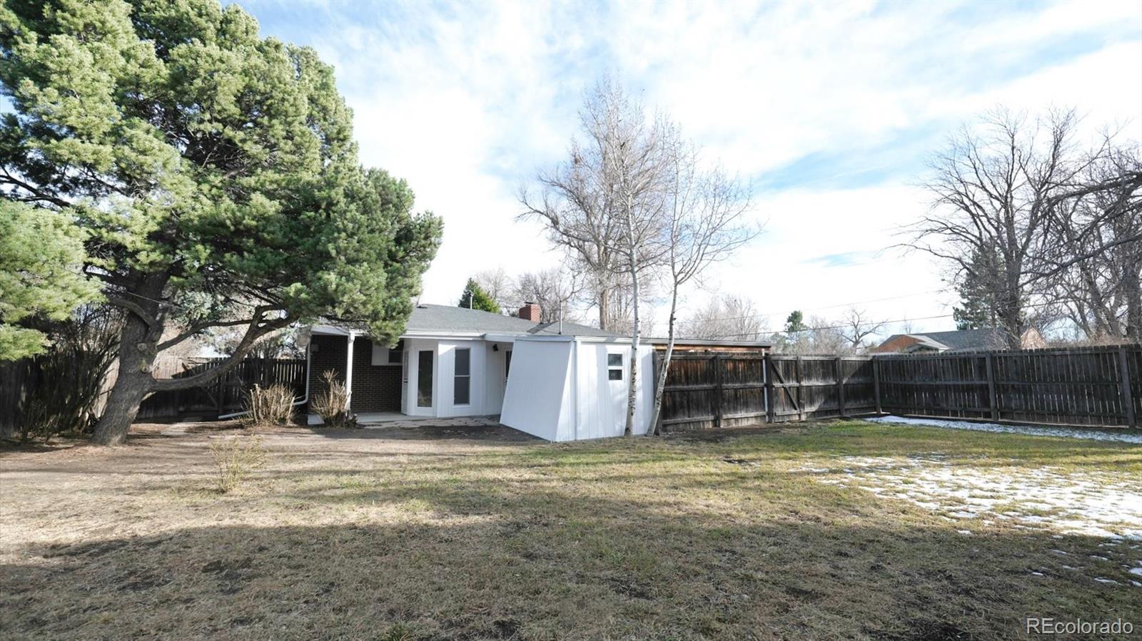 1201 Reed Street Lakewood, CO 80214 - Photo 42 of 44 a view of a backyard with a large tree