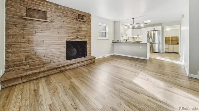 a view of a kitchen with wooden floor and a kitchen