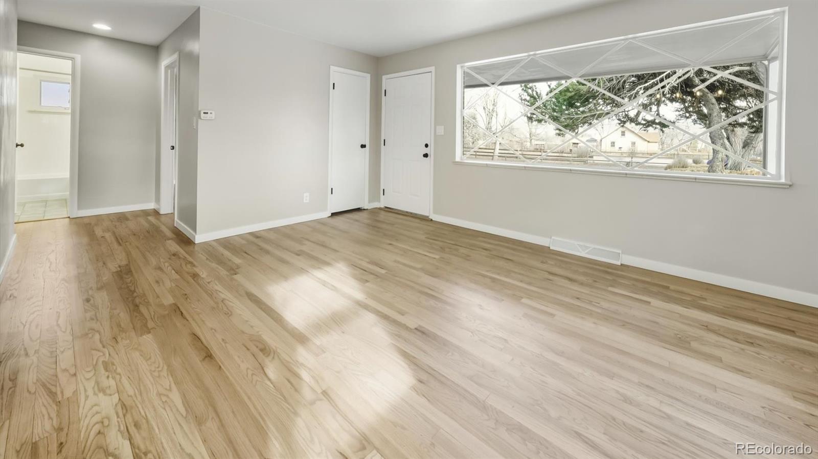1201 Reed Street Lakewood, CO 80214 - Photo 10 of 44 a view of empty room with wooden floor and fan