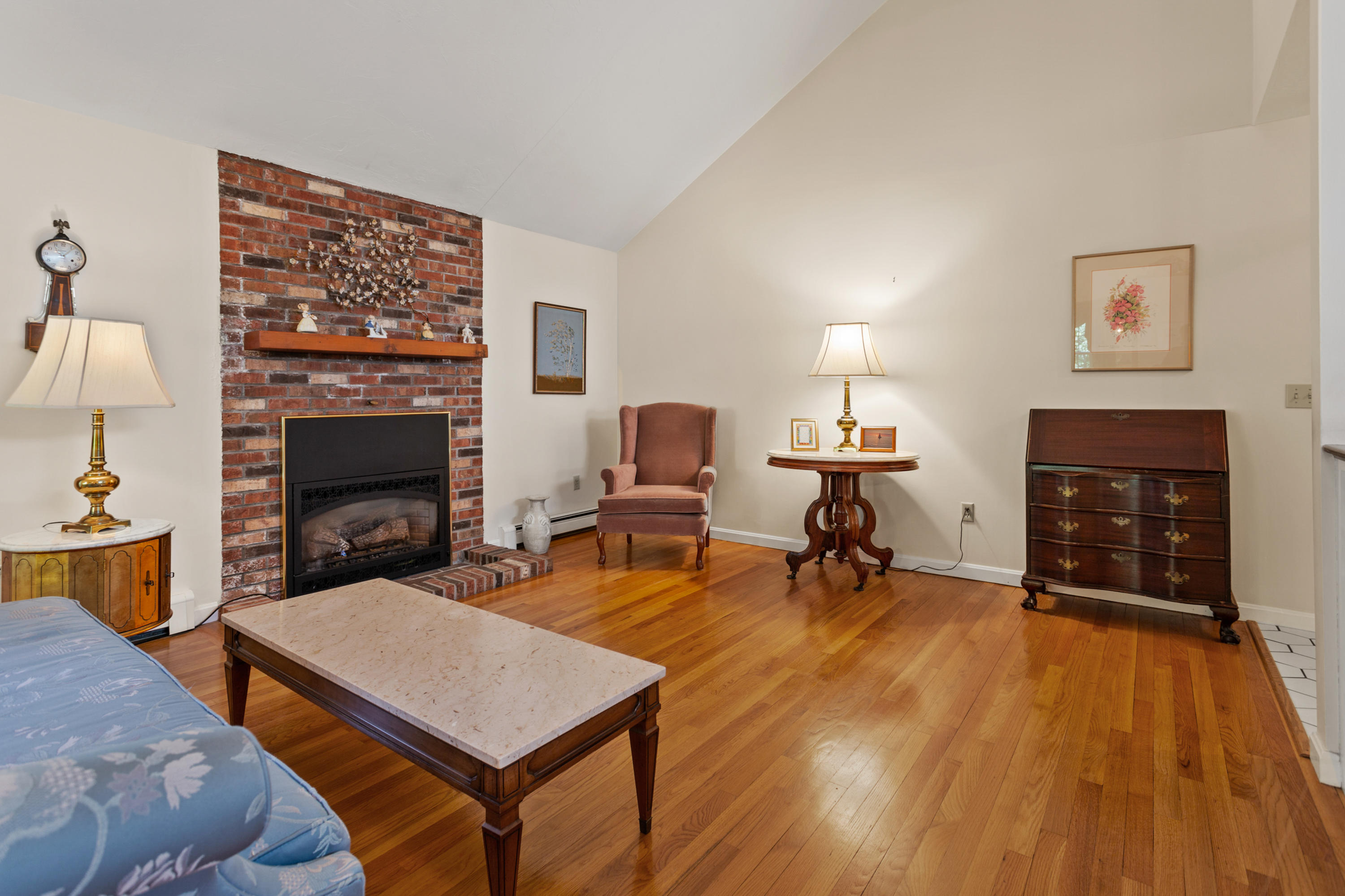 82 Clamshell Cove Road Cotuit, MA 02635 - Photo 11 of 34 a living room with furniture and a fireplace