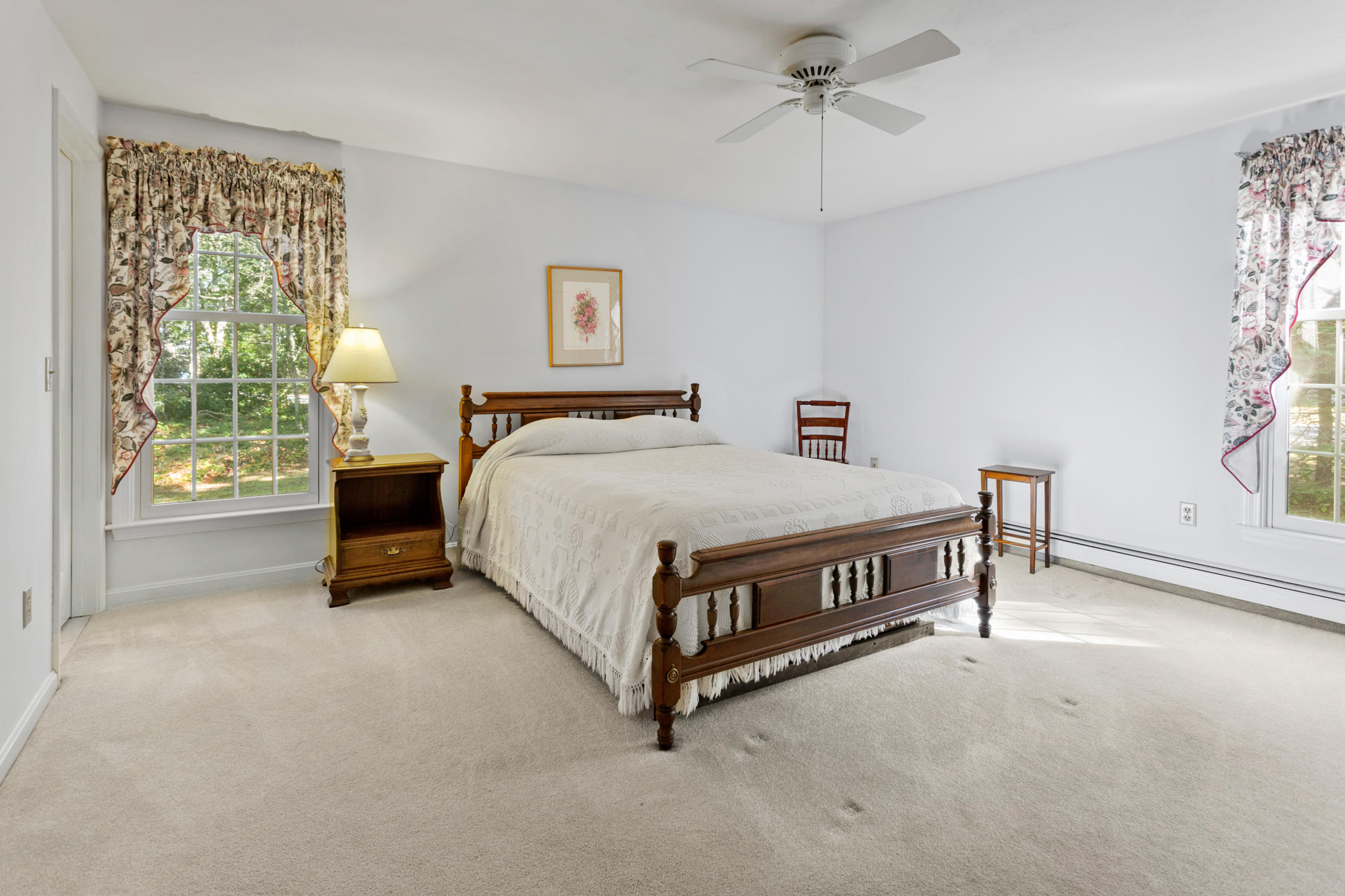 82 Clamshell Cove Road Cotuit, MA 02635 - Photo 27 of 34 a bedroom with a bed table and a window