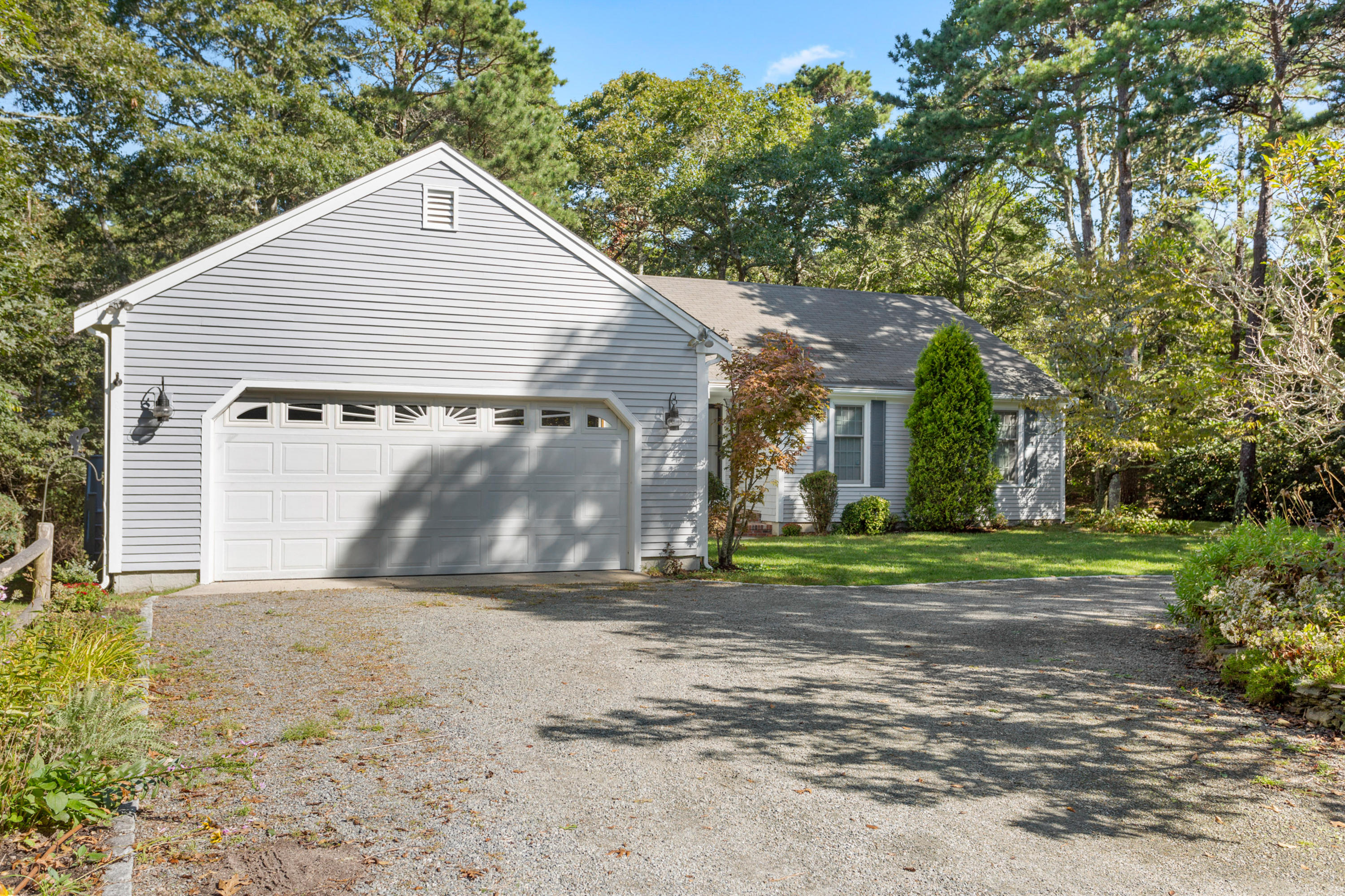82 Clamshell Cove Road Cotuit, MA 02635 - Photo 4 of 34 a view of a house with a yard and garage