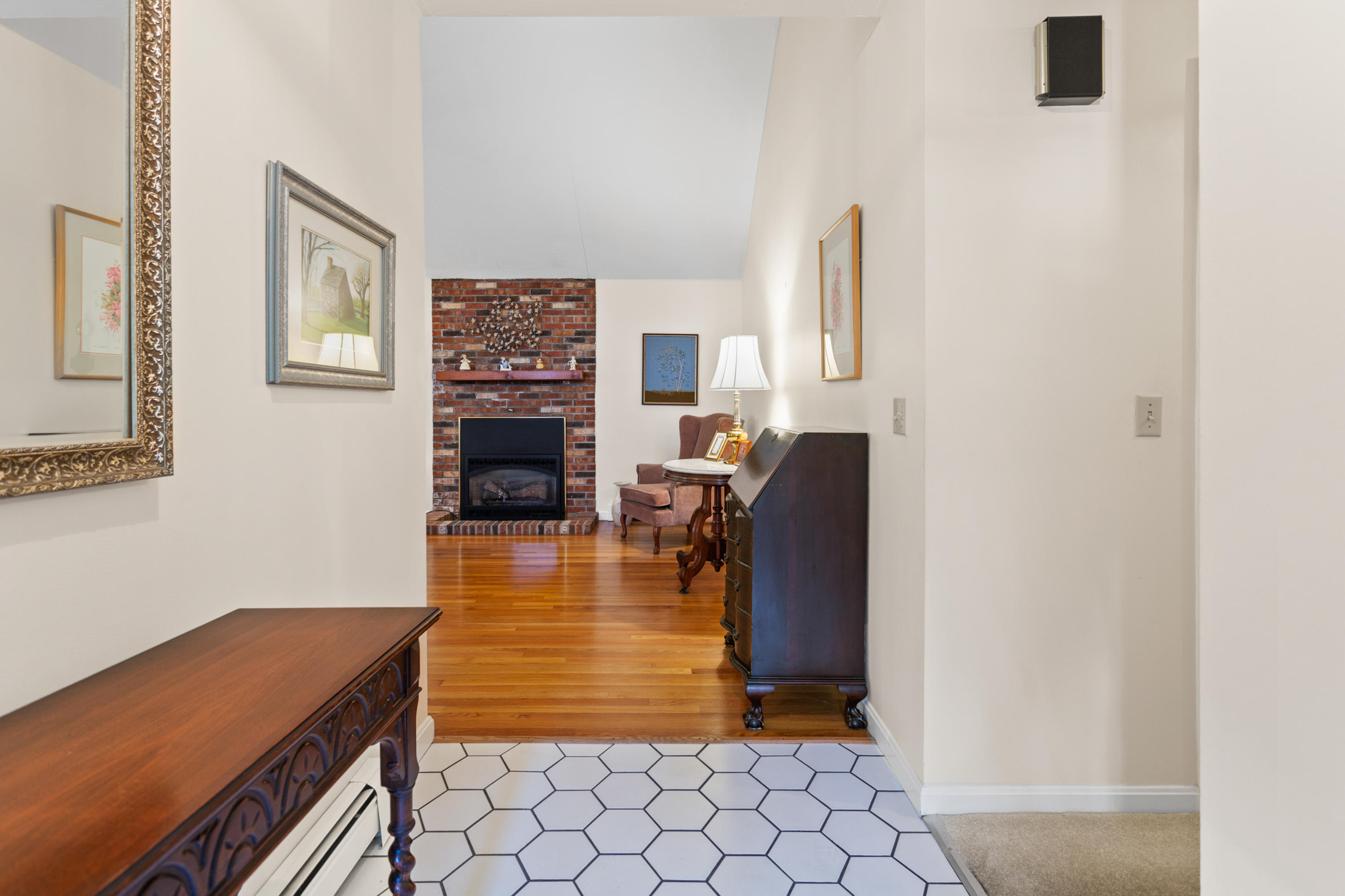 82 Clamshell Cove Road Cotuit, MA 02635 - Photo 5 of 34 a living room with furniture and a fireplace