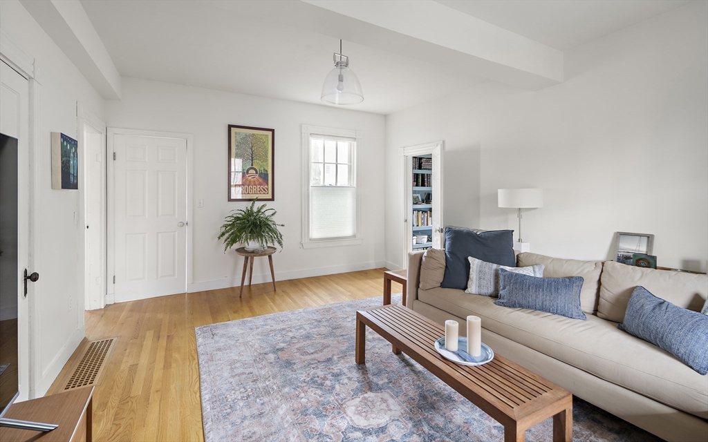 16 Blake Street Cambridge, MA 02140 - Photo 12 of 37 a living room with furniture a wooden floor and a chandelier