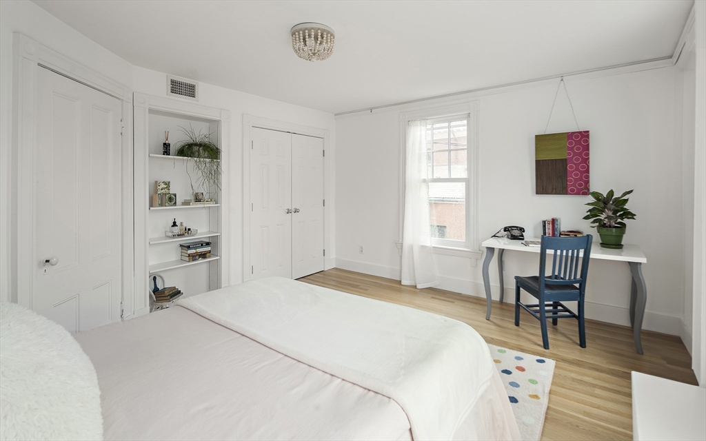 16 Blake Street Cambridge, MA 02140 - Photo 17 of 37 a bedroom with a bed and a chair in it