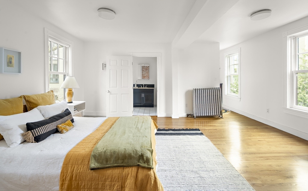 16 Blake Street Cambridge, MA 02140 - Photo 24 of 37 a spacious bedroom with a bed and wooden floor