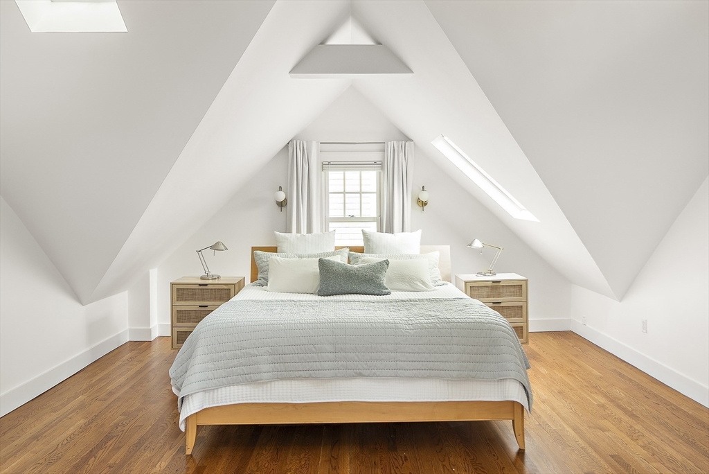 16 Blake Street Cambridge, MA 02140 - Photo 26 of 37 a bedroom with a large bed and wooden floor