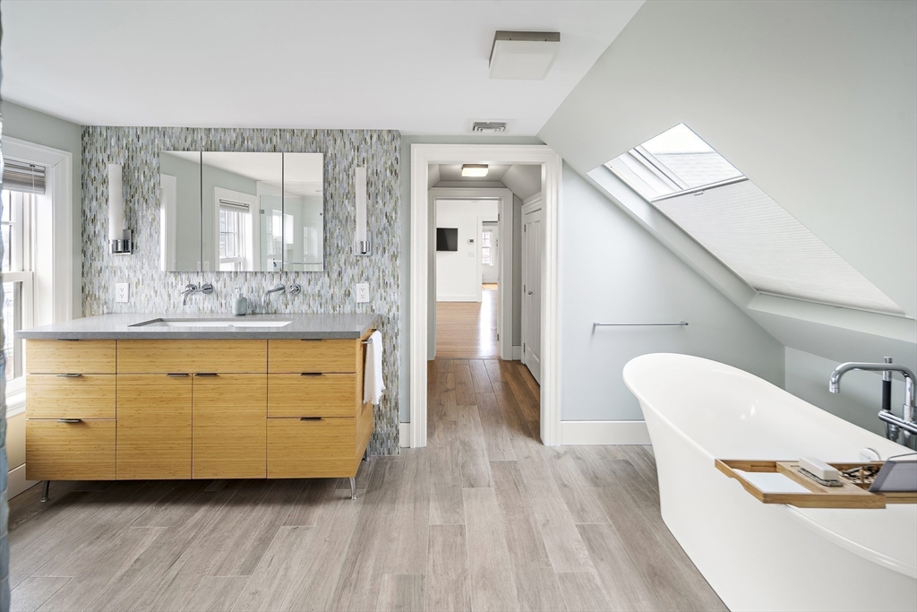 16 Blake Street Cambridge, MA 02140 - Photo 30 of 37 a bathroom with a double vanity sink a mirror and a bathtub