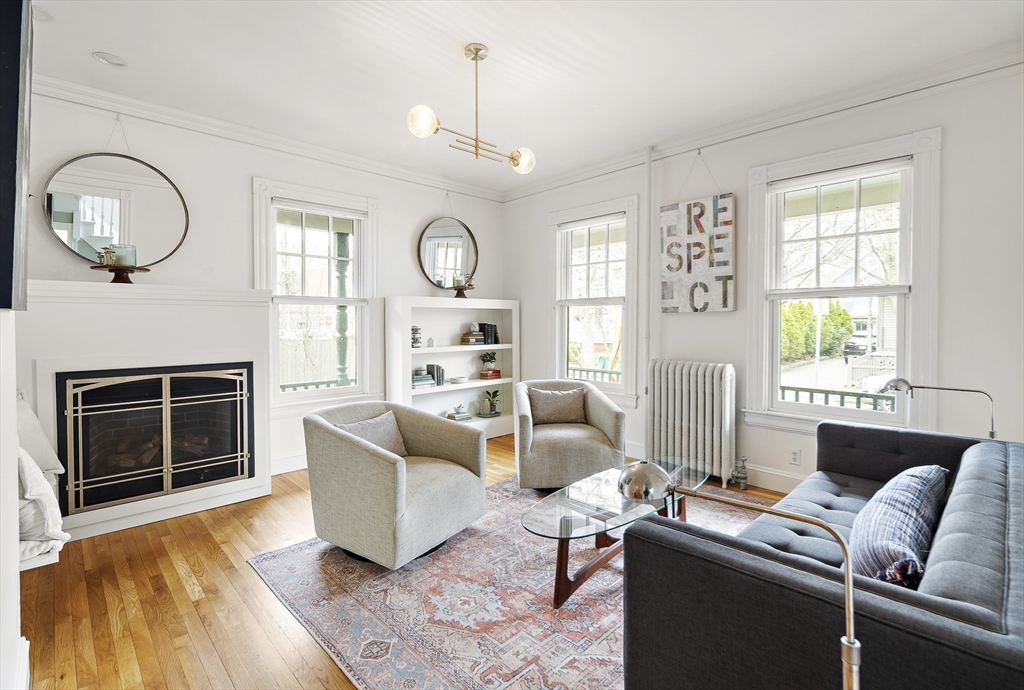 16 Blake Street Cambridge, MA 02140 - Photo 4 of 37 a living room with furniture a fireplace and a window