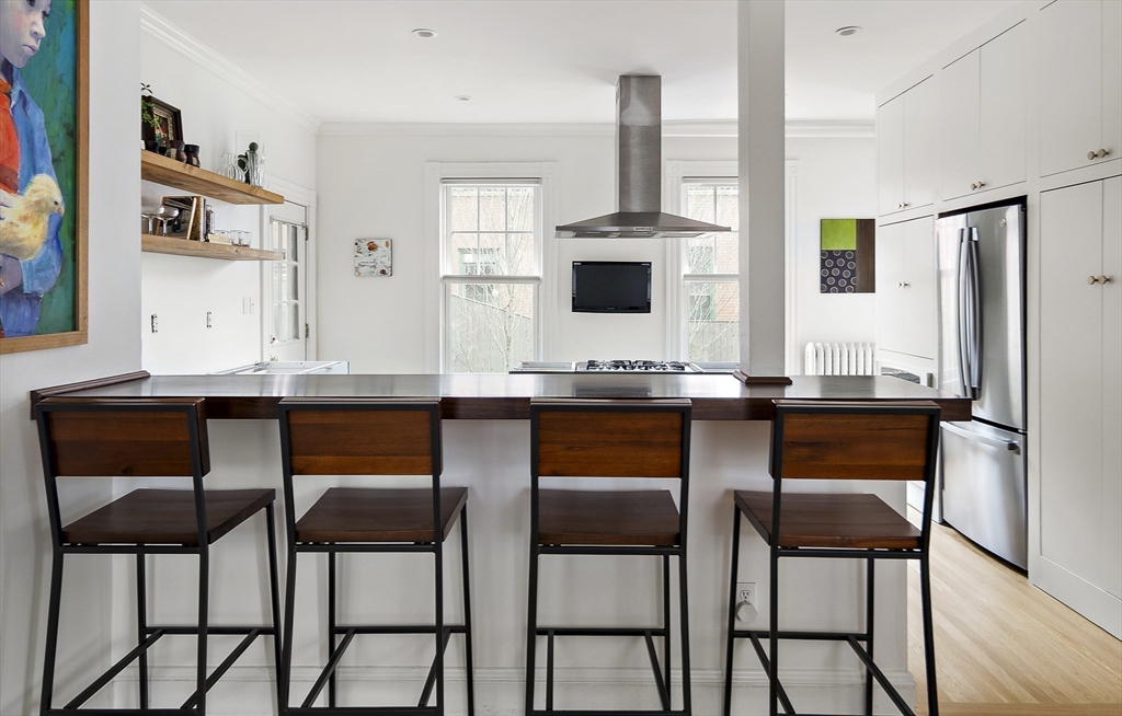 16 Blake Street Cambridge, MA 02140 - Photo 8 of 37 a living room with stainless steel appliances kitchen island granite countertop furniture and a wooden floor
