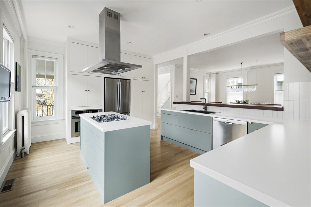 16 Blake Street Cambridge, MA 02140 - Photo 10 of 37 a kitchen with kitchen island stainless steel appliances a stove and a refrigerator