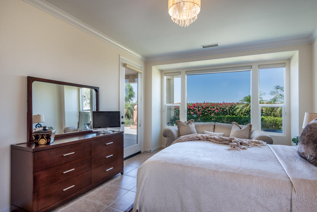 81820 Eagle Claw Drive La Quinta, CA 92253 - Photo 11 of 36 a bed room with a bed large window and mirror