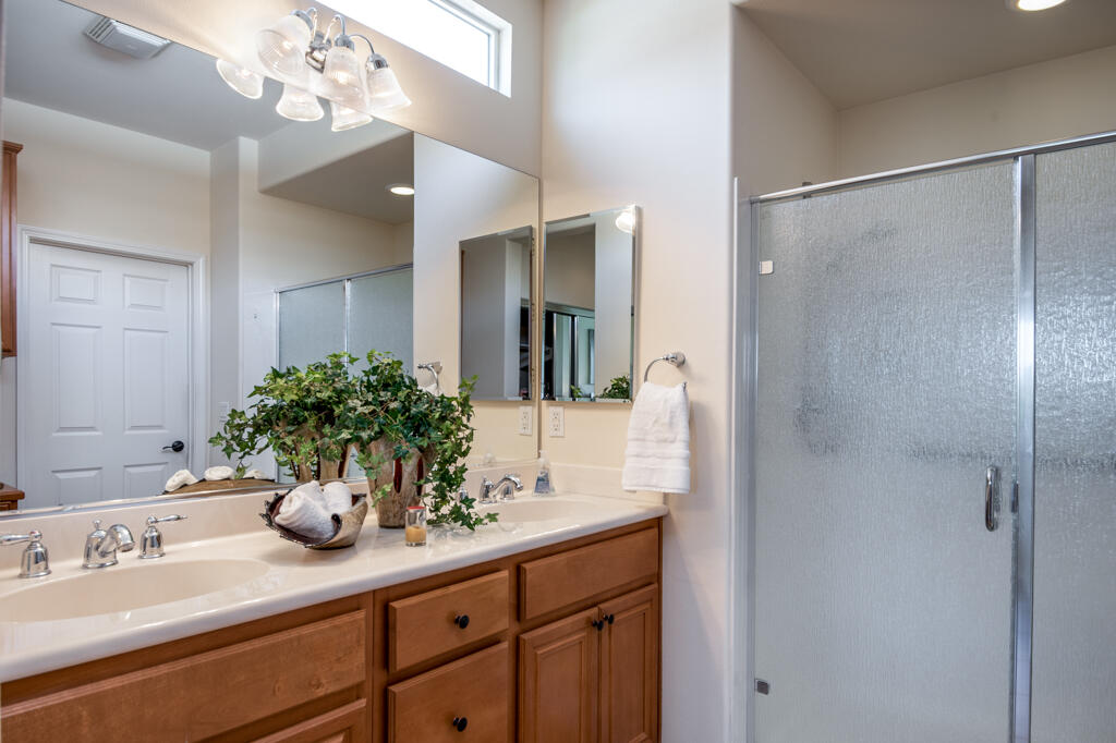 81820 Eagle Claw Drive La Quinta, CA 92253 - Photo 12 of 36 a bathroom with a sink a mirror and a shower