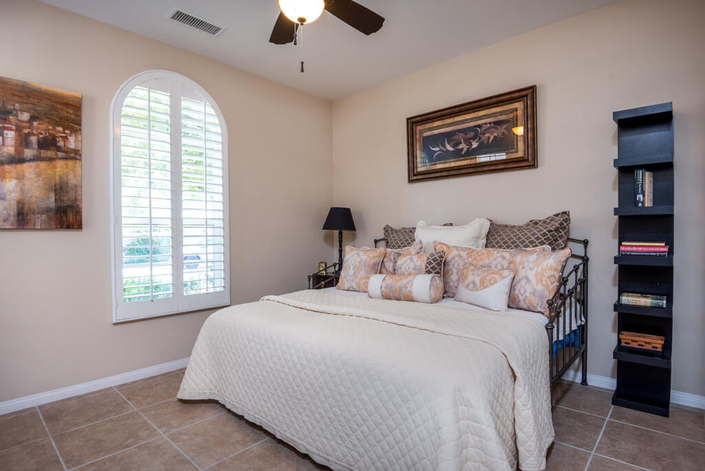 81820 Eagle Claw Drive La Quinta, CA 92253 - Photo 16 of 36 a bedroom with a large bed and a window