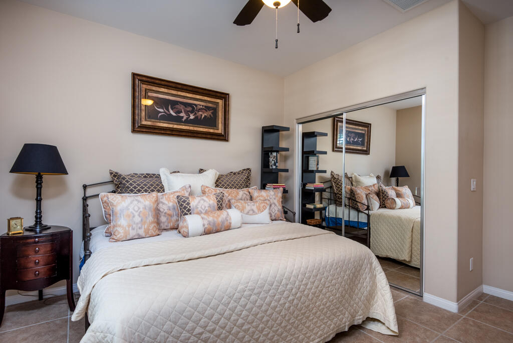 81820 Eagle Claw Drive La Quinta, CA 92253 - Photo 17 of 36 a bedroom with a bed and a chandelier