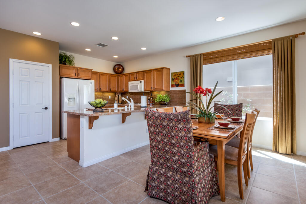 81820 Eagle Claw Drive La Quinta, CA 92253 - Photo 5 of 36 a dining room with furniture a table and kitchen view