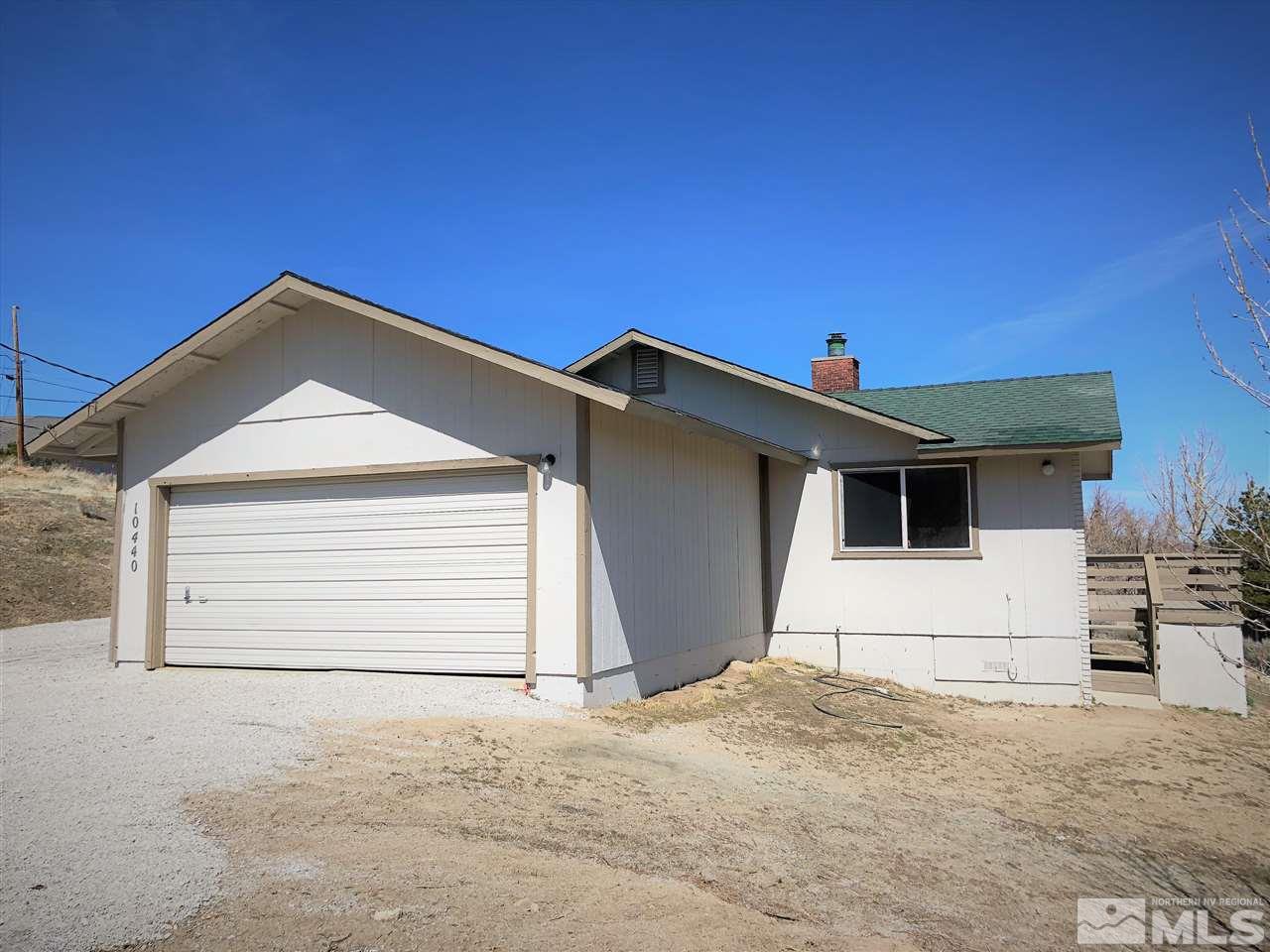 10440 San Fernando Road Reno, NV 89508 - Photo 22 of 24 a front view of a house with a garage