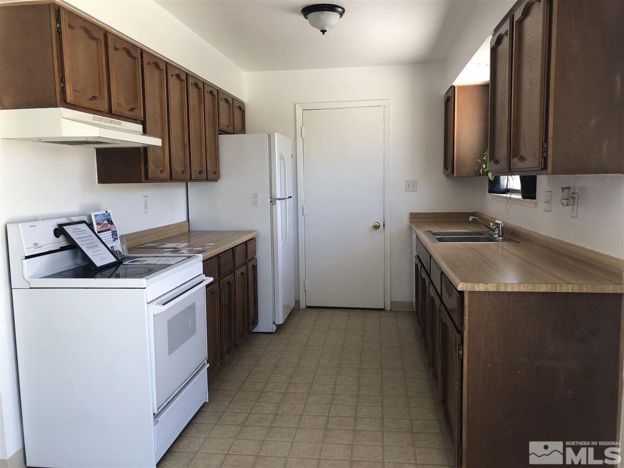 10440 San Fernando Road Reno, NV 89508 - Photo 8 of 24 a kitchen with stainless steel appliances granite countertop a sink stove and refrigerator