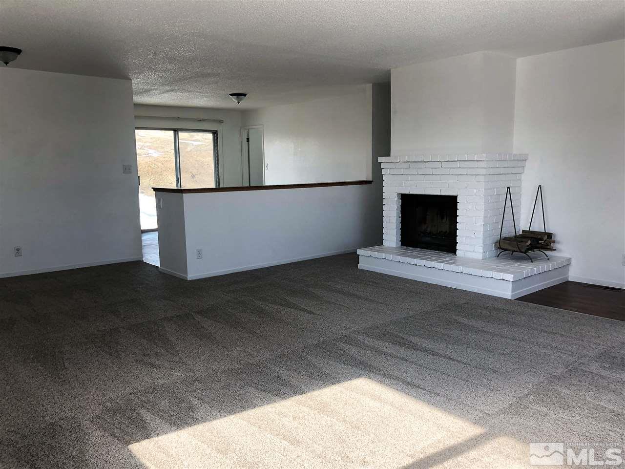 10440 San Fernando Road Reno, NV 89508 - Photo 9 of 24 a view of empty room with fireplace