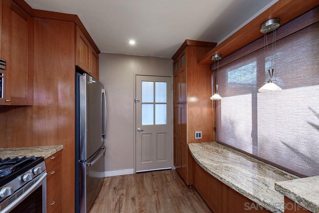 2414 Monroe Avenue San Diego, CA 92116 - Photo 11 of 65 a kitchen with granite countertop wooden cabinets and a stainless steel appliances