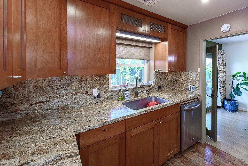 2414 Monroe Avenue San Diego, CA 92116 - Photo 12 of 65 a kitchen with stainless steel appliances granite countertop a sink and a wooden cabinets