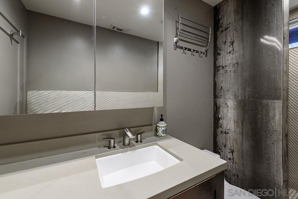 2414 Monroe Avenue San Diego, CA 92116 - Photo 22 of 65 a bathroom with a sink and a mirror