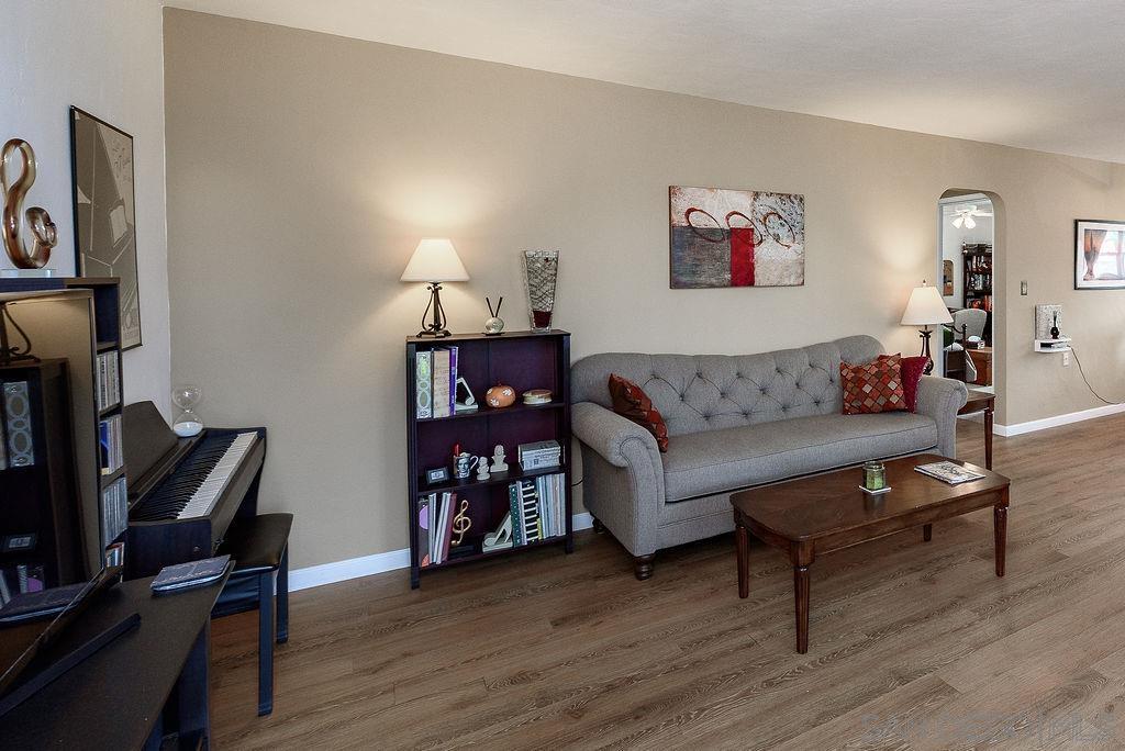 2414 Monroe Avenue San Diego, CA 92116 - Photo 47 of 65 a living room with furniture a lamp and wooden floor