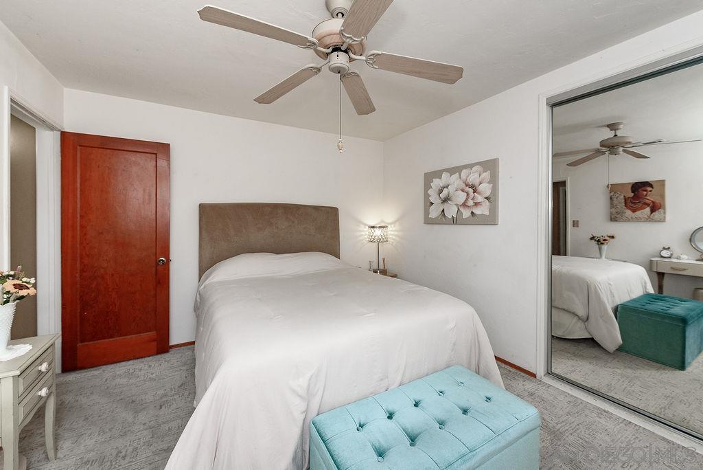 2414 Monroe Avenue San Diego, CA 92116 - Photo 57 of 65 a bedroom with a bed and a ceiling fan