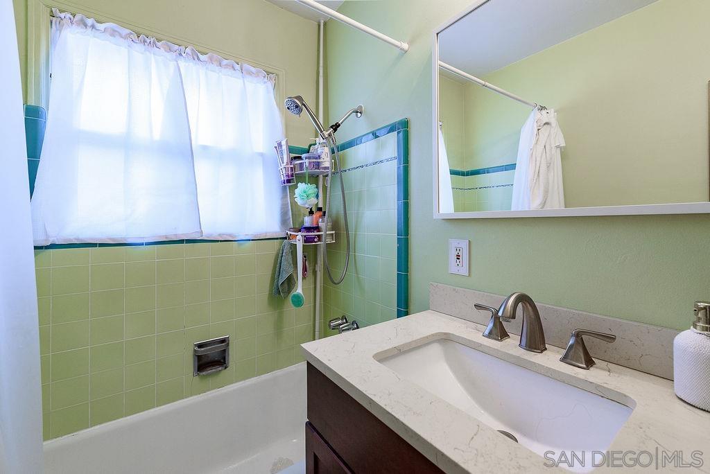 2414 Monroe Avenue San Diego, CA 92116 - Photo 59 of 65 a bathroom with a sink and a mirror