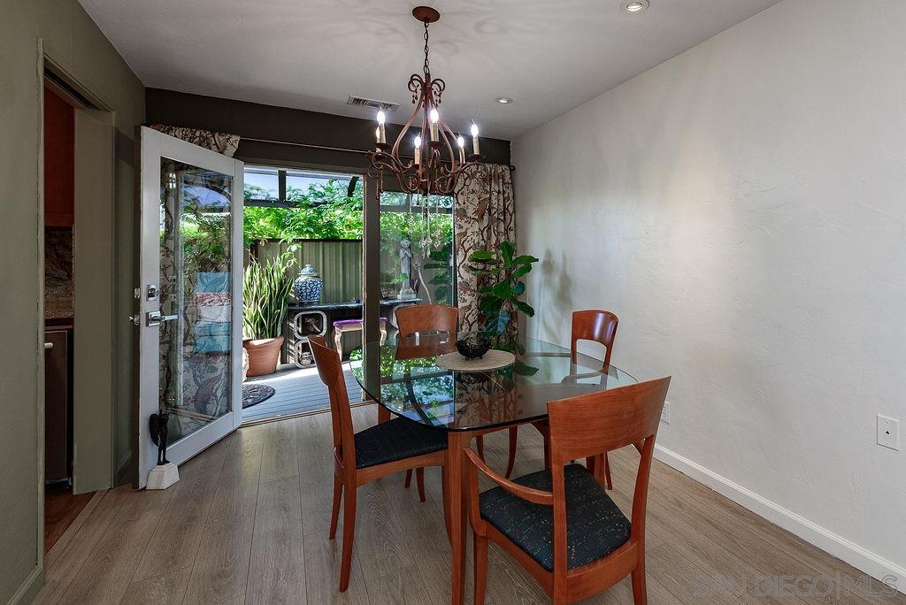 2414 Monroe Avenue San Diego, CA 92116 - Photo 7 of 65 a dining room with furniture a chandelier and wooden floor