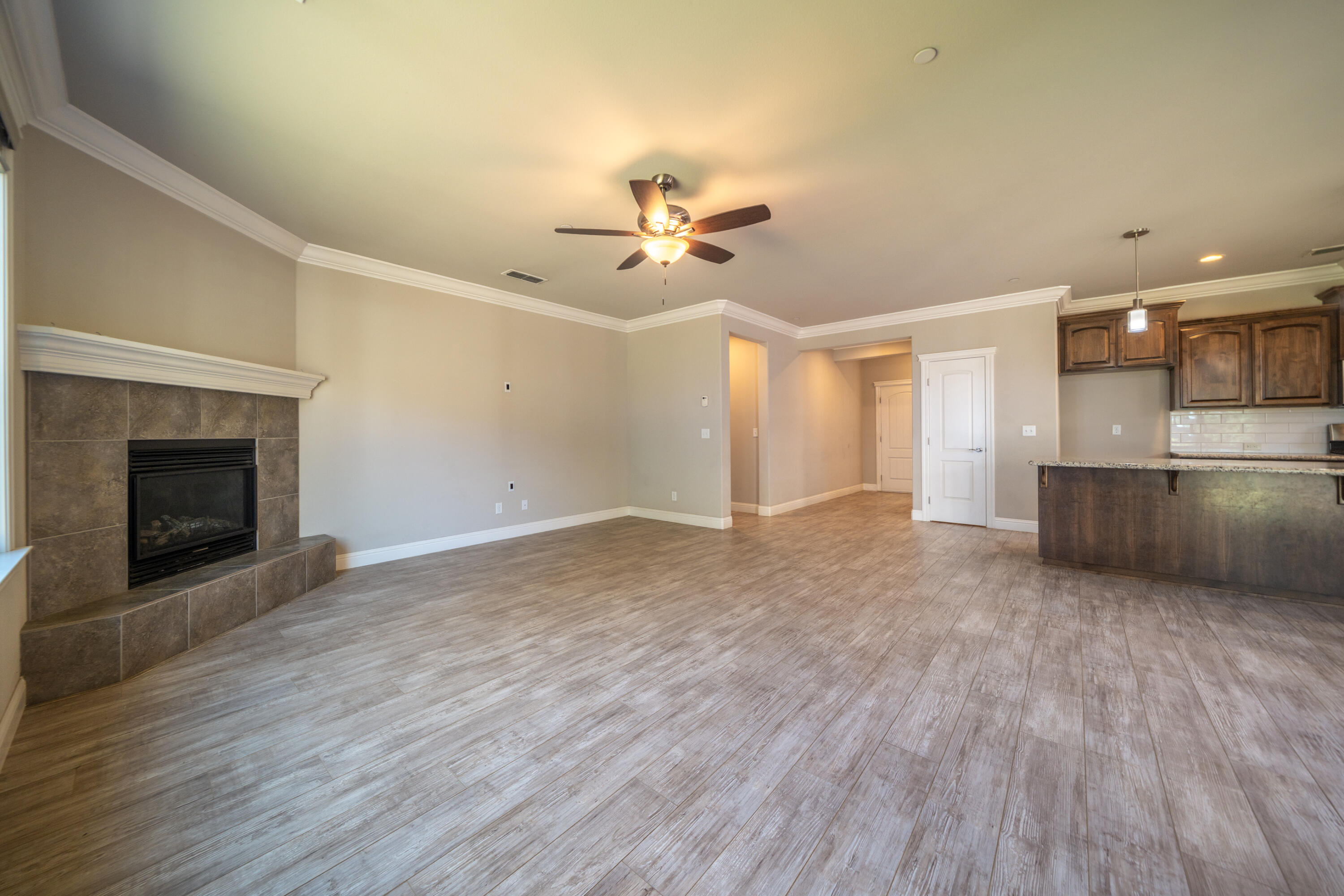 5571 Muir Peak Road Redding, CA 96002 - Photo 12 of 42 a view of a kitchen with a dishwasher a kitchen wooden floor and a fireplace
