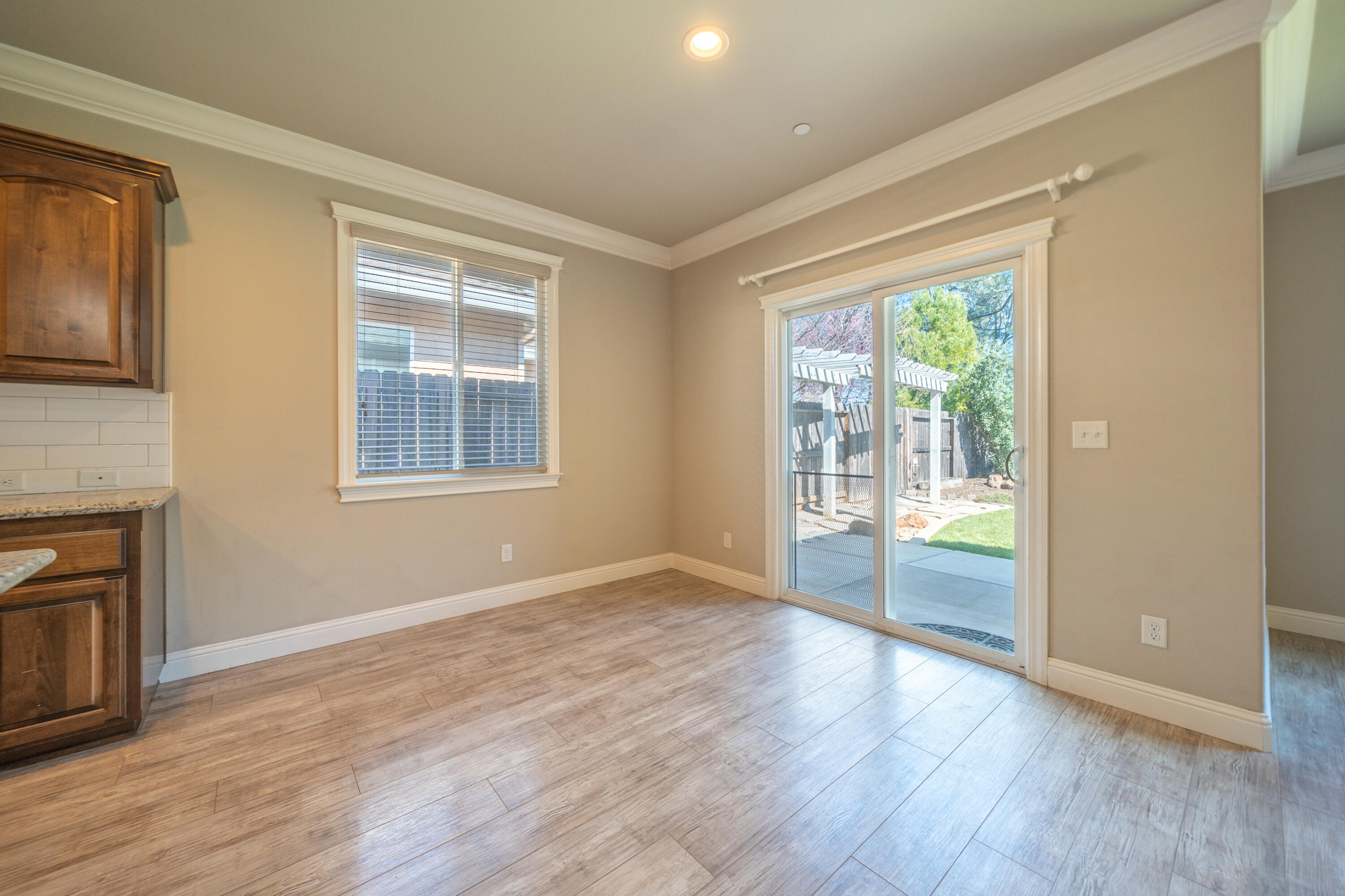 5571 Muir Peak Road Redding, CA 96002 - Photo 14 of 42 a view of an empty room with wooden floor and a window